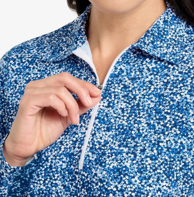 Close-up of a person wearing a blue and white speckled jacket with a zipper.